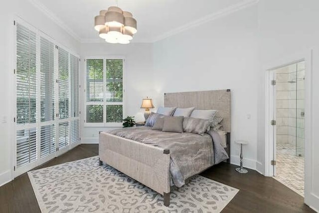 bedroom with ornamental molding, dark hardwood / wood-style floors, and a notable chandelier