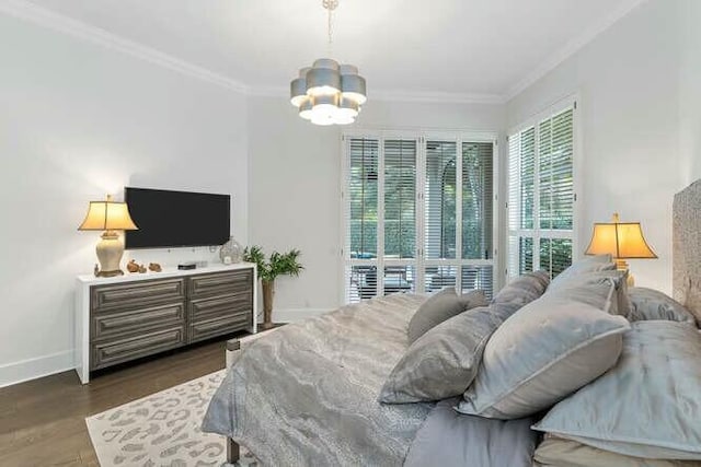 bedroom featuring ornamental molding, dark hardwood / wood-style floors, and an inviting chandelier