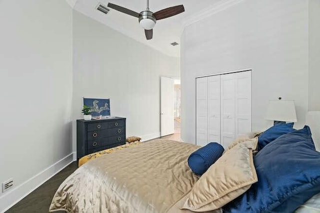 bedroom featuring high vaulted ceiling, a closet, crown molding, and ceiling fan