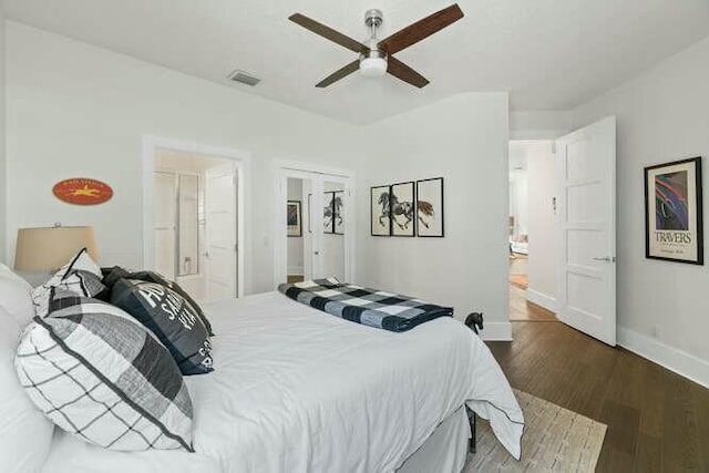 bedroom featuring ensuite bath, ceiling fan, and dark wood-type flooring