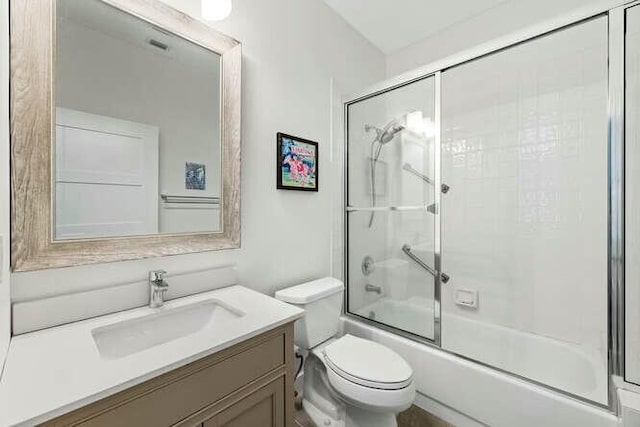 full bathroom with shower / bath combination with glass door, vanity, and toilet