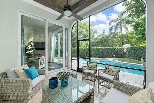 sunroom / solarium featuring ceiling fan