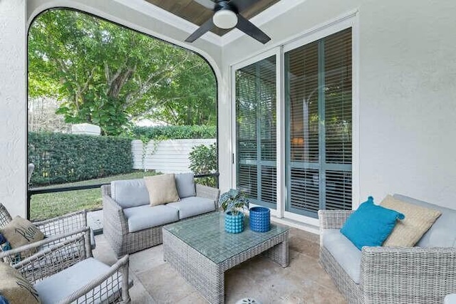 sunroom / solarium featuring ceiling fan