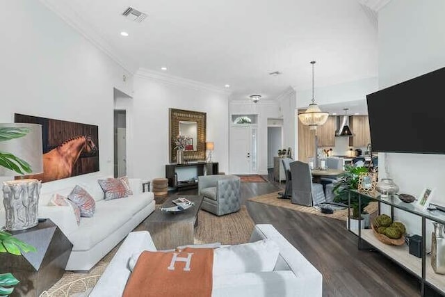 living room with hardwood / wood-style flooring and crown molding