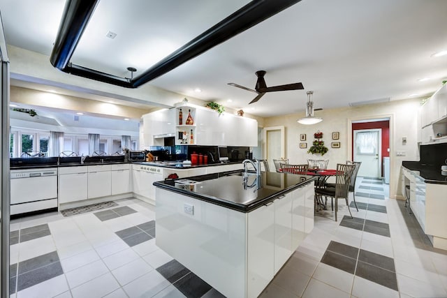 kitchen featuring ceiling fan, white cabinetry, kitchen peninsula, and hanging light fixtures