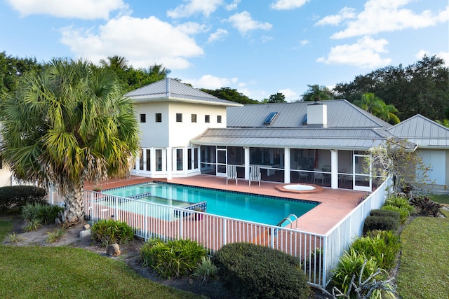 view of swimming pool featuring a patio area and a sunroom