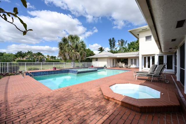 view of swimming pool with a patio and an in ground hot tub