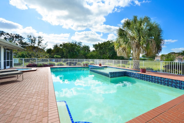 view of pool featuring an in ground hot tub and a patio