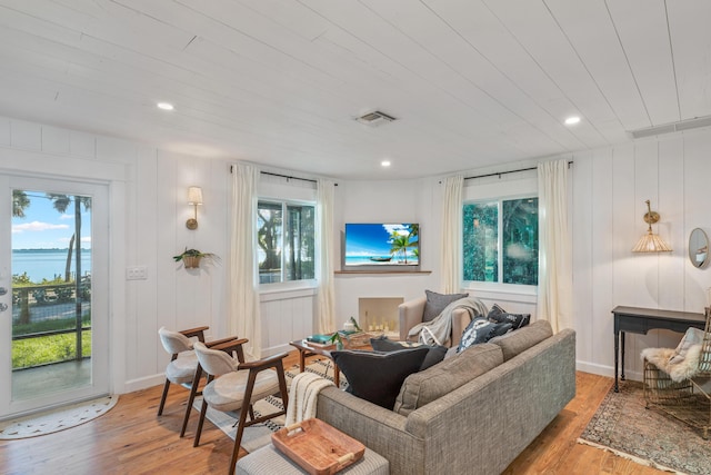 living room featuring light hardwood / wood-style floors and wooden ceiling