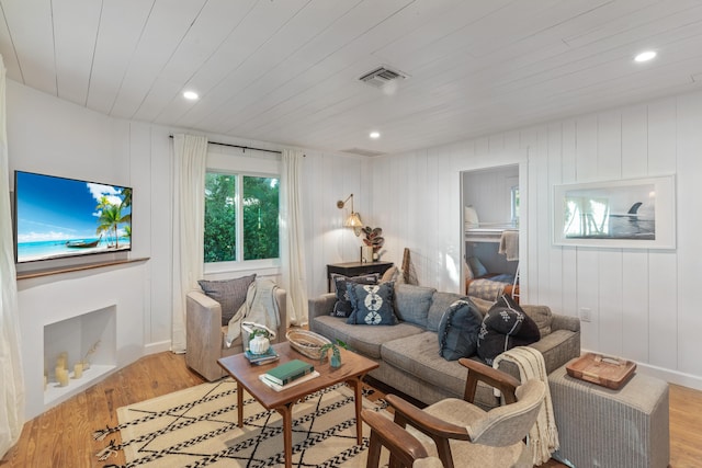 living room featuring light wood-type flooring and wood ceiling