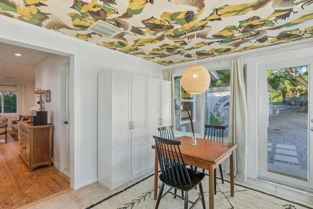 tiled dining room with a healthy amount of sunlight