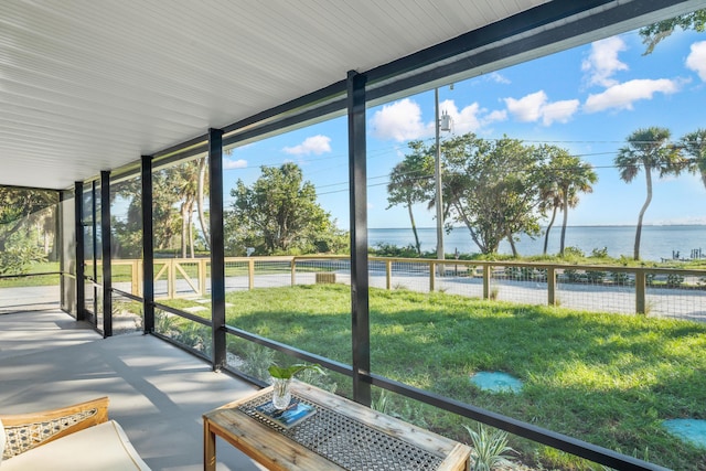 unfurnished sunroom with a water view