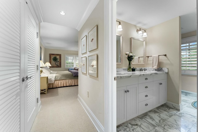 bathroom featuring ornamental molding and vanity