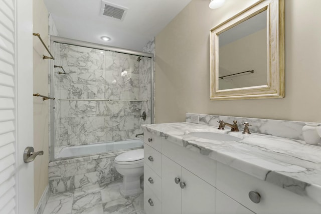 full bathroom featuring tiled shower / bath combo, vanity, and toilet