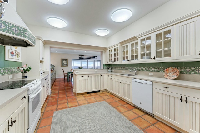 kitchen with extractor fan, sink, white appliances, and tasteful backsplash