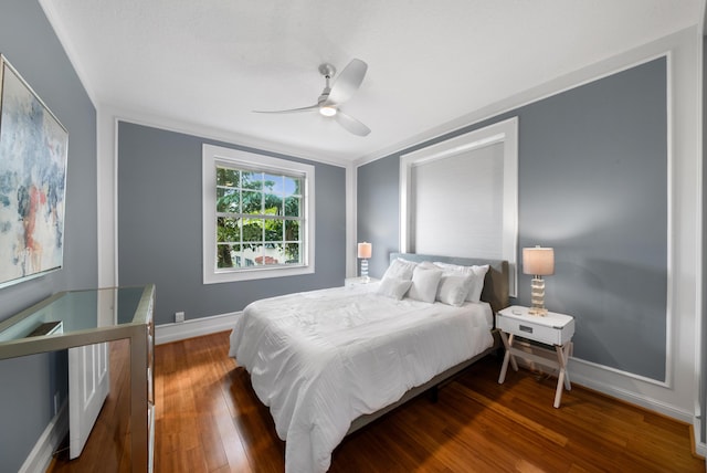 bedroom featuring ceiling fan, dark wood-type flooring, and crown molding