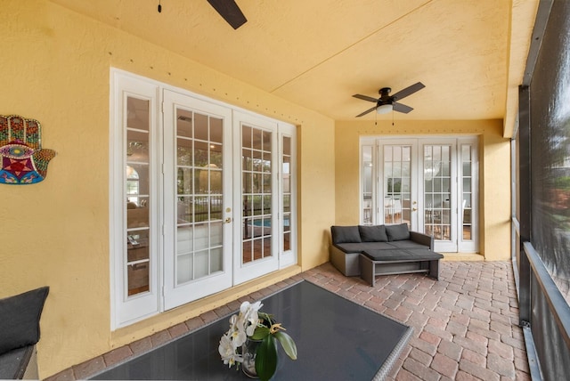 sunroom / solarium with ceiling fan and french doors