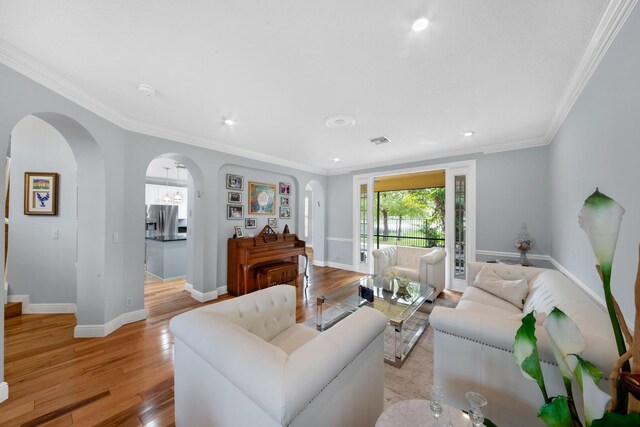 living room featuring light hardwood / wood-style flooring and ornamental molding