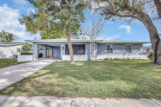 single story home with a front lawn and a carport