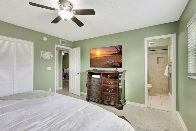 bedroom featuring ceiling fan, a closet, a textured ceiling, and ensuite bath