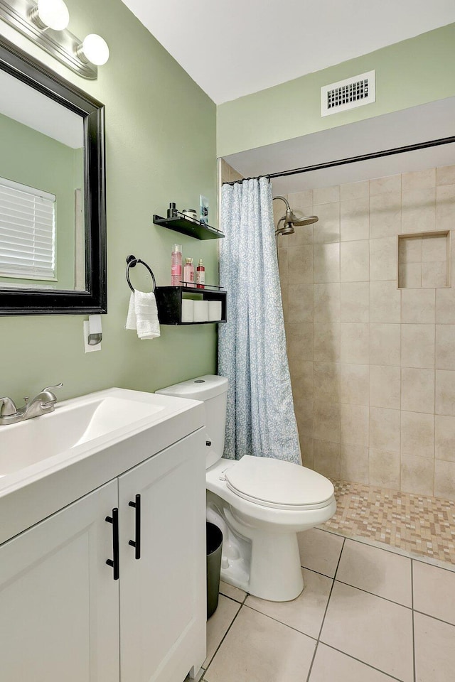 bathroom featuring walk in shower, tile patterned floors, toilet, and vanity