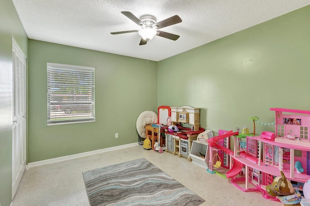 game room featuring ceiling fan and a textured ceiling