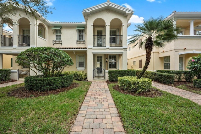 mediterranean / spanish-style house with a front yard