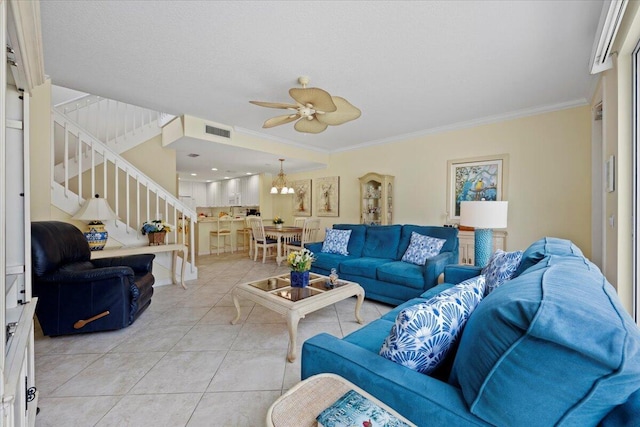 living room with ornamental molding, light tile patterned floors, and ceiling fan