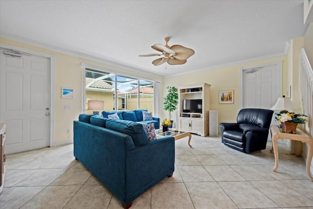 tiled living room featuring crown molding, ceiling fan, and a textured ceiling