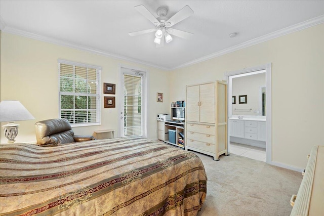 bedroom featuring ceiling fan, ornamental molding, connected bathroom, and light colored carpet