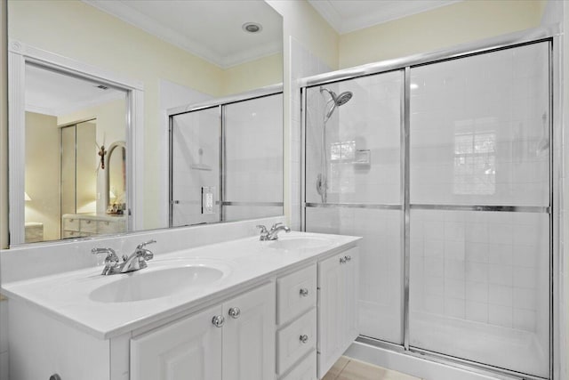 bathroom with vanity, tile patterned flooring, crown molding, and a shower with shower door