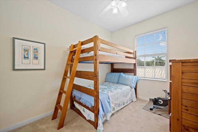 carpeted bedroom with multiple windows and ceiling fan