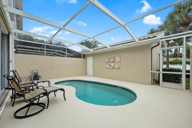 view of pool featuring a patio and glass enclosure