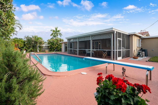 view of pool with a patio area and a sunroom