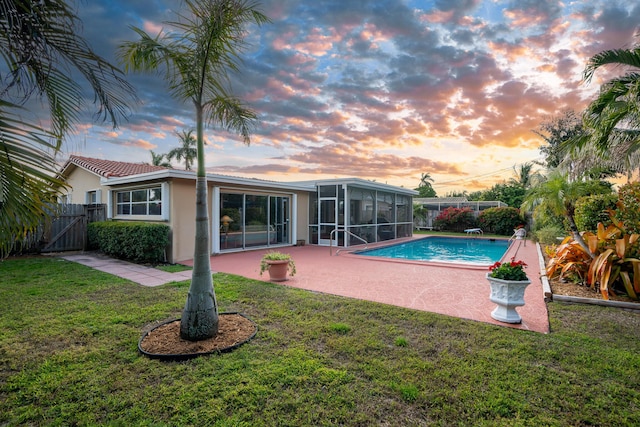 view of pool with a patio, fence, a yard, a gate, and a fenced in pool