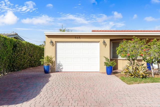 garage with decorative driveway