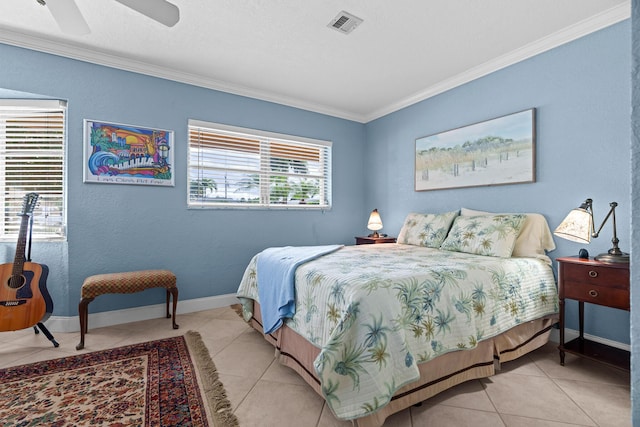 bedroom featuring light tile patterned floors, a ceiling fan, baseboards, visible vents, and crown molding