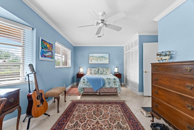 bedroom with light tile patterned floors, ceiling fan, ornamental molding, and baseboards