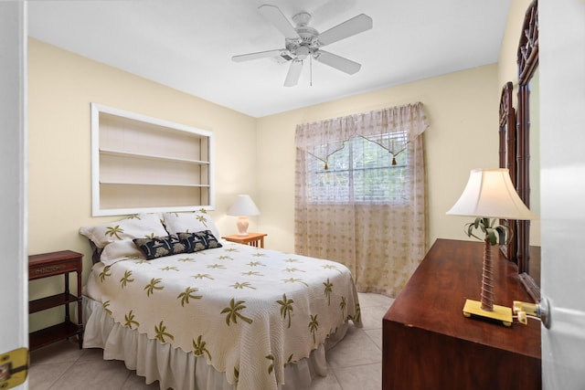 bedroom with ceiling fan and light tile patterned floors