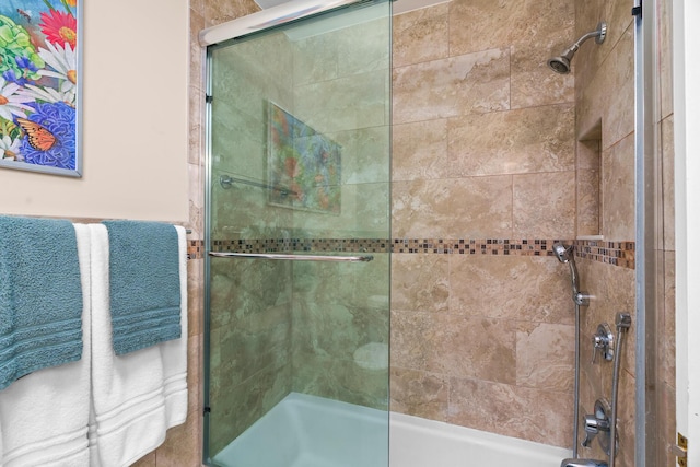 bathroom with bath / shower combo with glass door