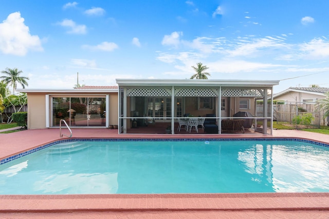 view of swimming pool with a fenced in pool, fence, grilling area, and a patio