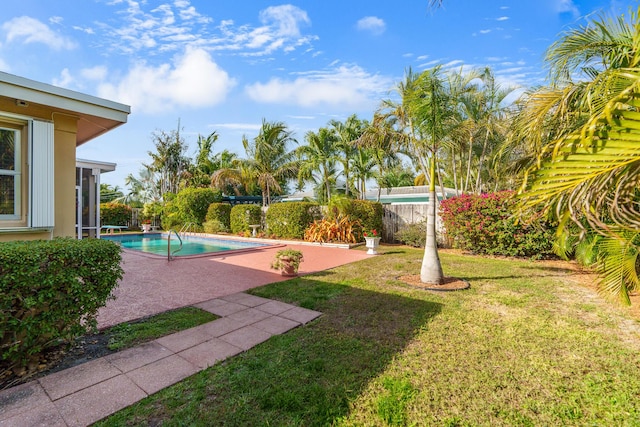 view of yard with a fenced backyard, a fenced in pool, and a patio