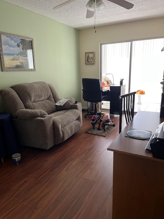 living room with a textured ceiling and hardwood / wood-style flooring