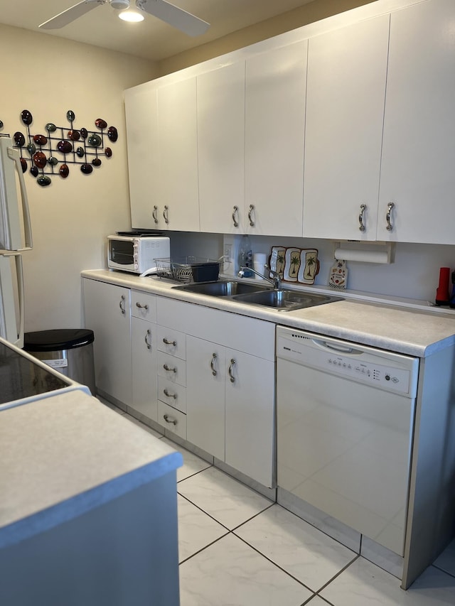 kitchen featuring sink, white cabinets, white appliances, and light tile patterned floors