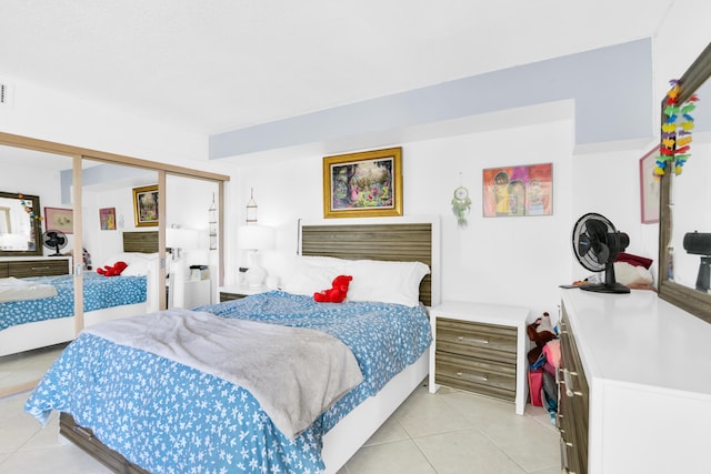 tiled bedroom featuring a closet