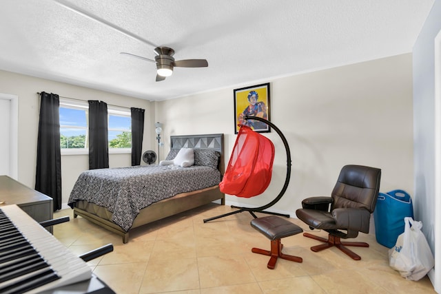 tiled bedroom featuring ceiling fan and a textured ceiling