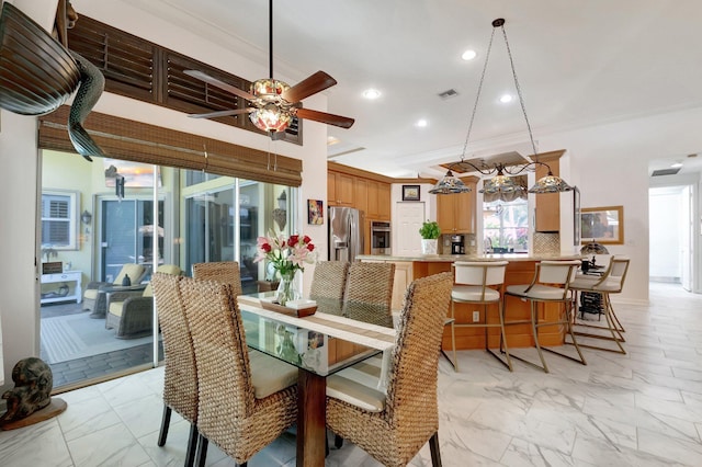 dining room with ceiling fan and ornamental molding