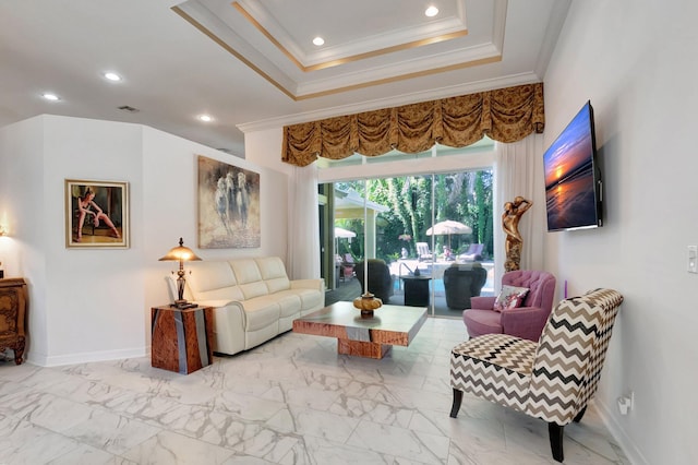 living room with a tray ceiling and ornamental molding