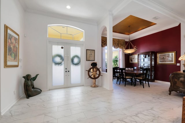 foyer entrance featuring ornamental molding and french doors