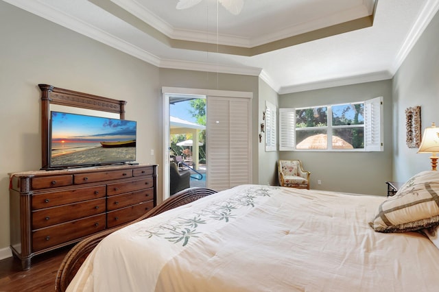 bedroom with access to outside, a raised ceiling, ceiling fan, and dark wood-type flooring